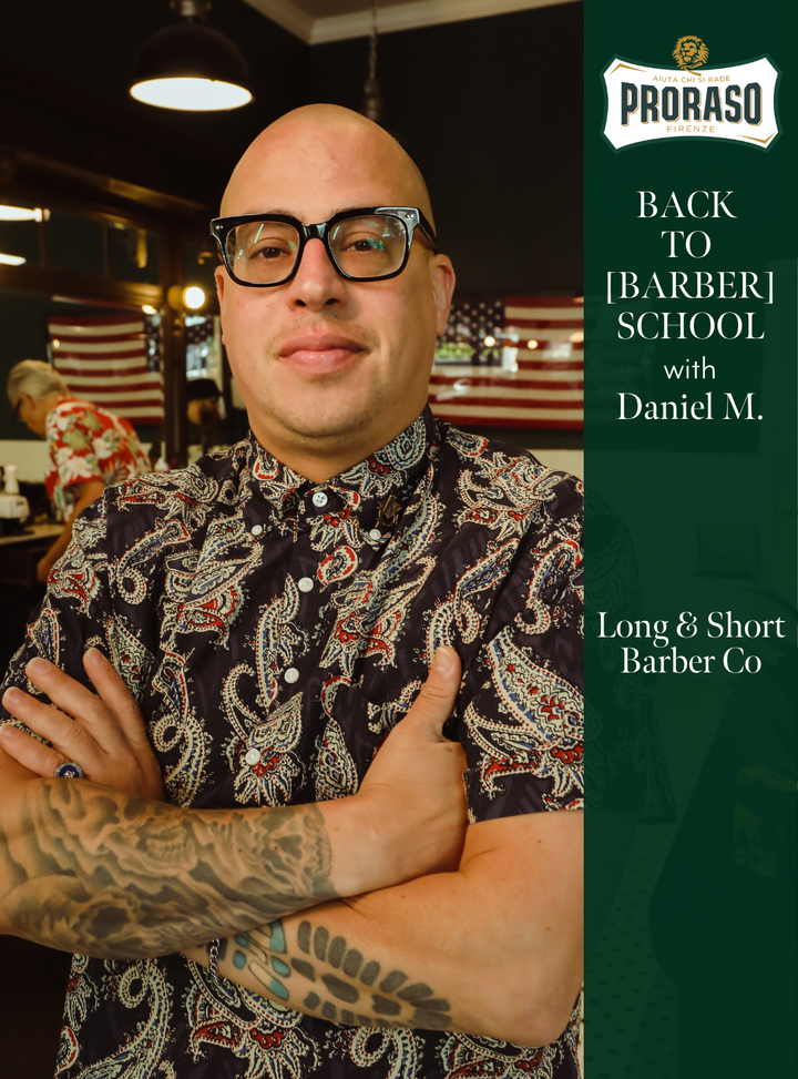 Daniel M. at Long & Short Barber Co. standing with his arms crossed.