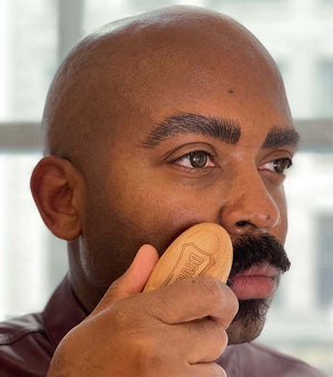 Proraso Moustache and Beard Brush being used to brush a short style moustache.