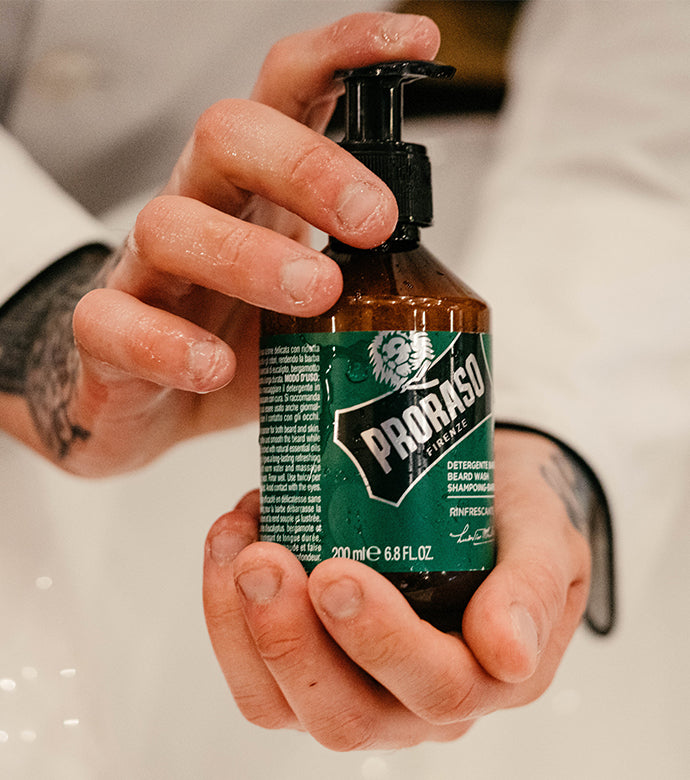 Proraso Refresh Beard Wash being held in hands.